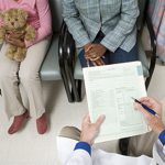 Doctor consulting parent and child