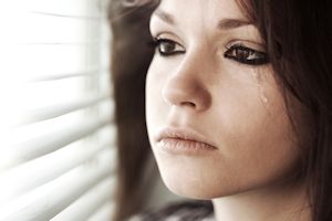 Close up of a girl with a tear running down her cheek. Girls with ADHD Internalize Struggles.