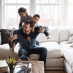 Shot of two adorable little boys having fun with their father at home