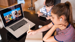 Teenage girl studying with video online lesson at home   family in isolation covid-19. Homeschooling and distance learning