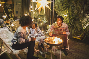 Family on porch making roasted marshmallow