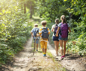 Mother and three kids hiking in forest. Family is having great time together.
Nikon D850