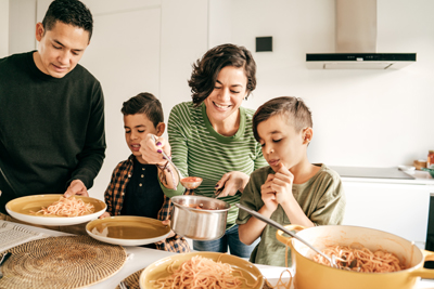 Dad and mom having  lunch with kids in the kitchen