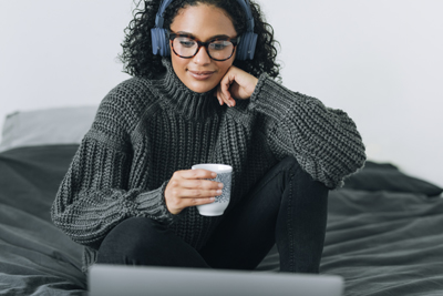 Happy woman working in her bedroom on her laptop pc, the new normal concept.