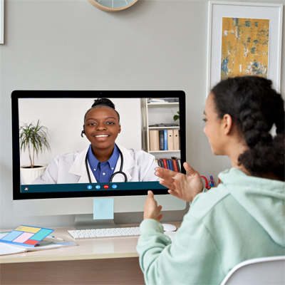 Teen Girl using computer to meet with doctor Newsletter