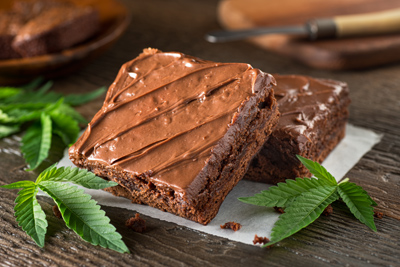 Delicious homemade pot brownies with marijuana leaf garnish.