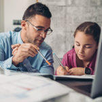 Father and daughter studying at home during coronavirus isolation