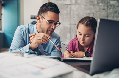 Father and daughter studying at home during coronavirus isolation