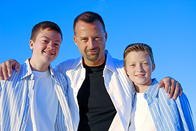 A father and his sons with blue sky as a background.Additional images of these models found here:  http://www.istockphoto.com/file_search.phpaction=file&amp;lightboxID=2781799