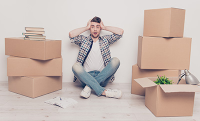 Student checkered casual shirt outfit space place people bad difficult concept. Exhausted frustrated going crazy guy touching head with hands crossed legs confused about the amount of belongings