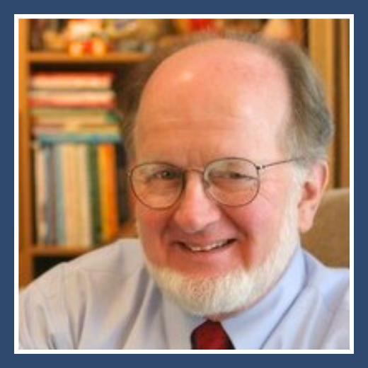 A portrait image of the late Thomas E. Brown, PhD smiling in front of a bookshelf.